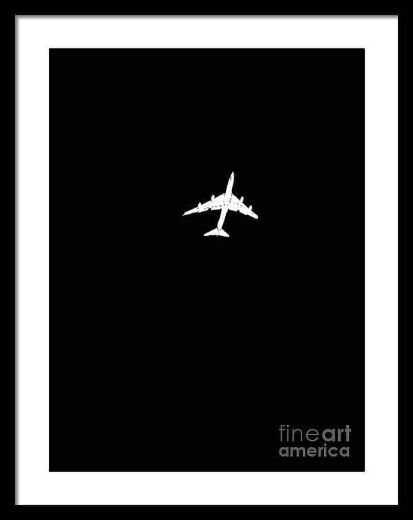 Airplane Silhouette Against Deep Black Sky Framed Print